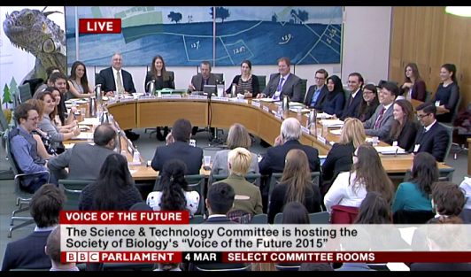 Young scientist discussing in a round table with UK's members of the parliament