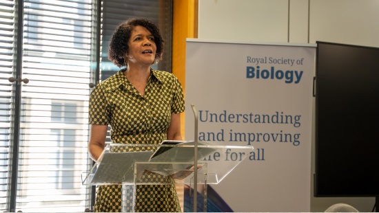 Dame Chi Onwurah MP at lectern giving speech in front of RSB banner